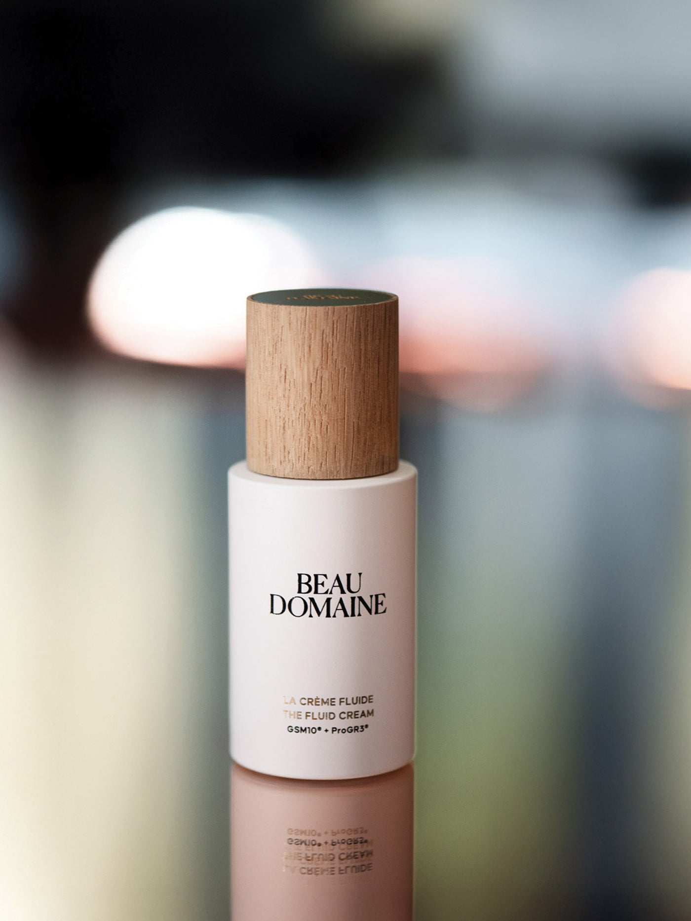 Beauty product with wooden cap and 'Beau Domaine' branding on a blurred background